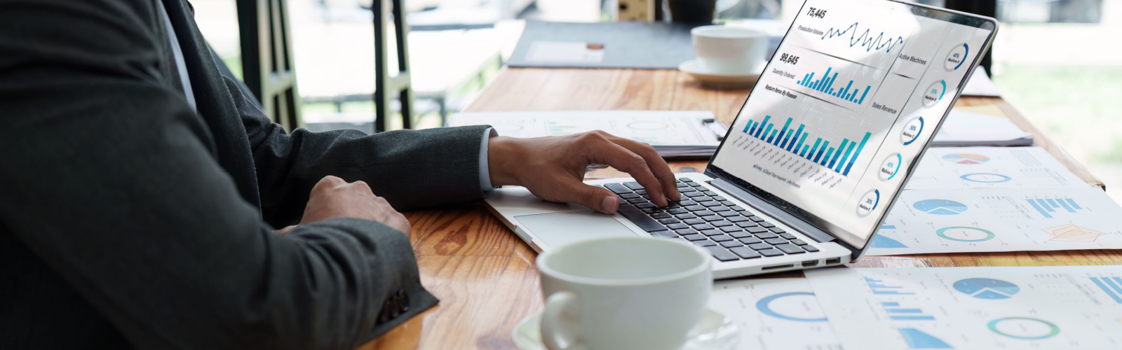 An advisor reviewing financial charts and reports at a desk